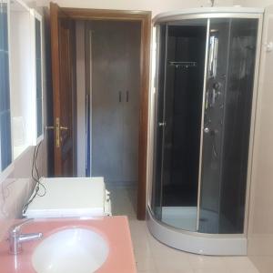 a bathroom with a sink and a glass shower at Green House in Fondi