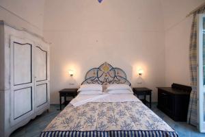 a bedroom with a large bed with two night stands at Palazzo Marzoli charme Resort - Small Luxury Hotel in Positano