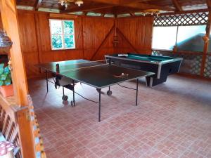 a room with two ping pong tables in it at Pension Calborean in Tălmăcel