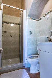 a bathroom with a toilet and a shower at Case Vacanze La Venere in Rocca Imperiale
