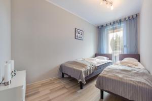 Säng eller sängar i ett rum på Apartamenty Sun & Snow Jantar Park