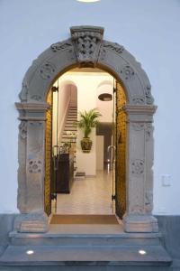 an archway leading into a house with a staircase at Palazzo Marzoli charme Resort - Small Luxury Hotel in Positano +37 photos