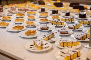 a table topped with plates of cakes and desserts at RVHotels Nieves Mar in L'Escala