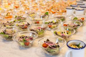 a table with many small bowls of different types of food at RVHotels Nieves Mar in L'Escala