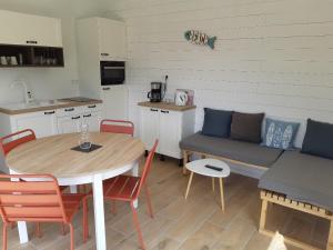 a living room with a table and a couch at ETABLISSEMENT CHEZ JULES in Ambleteuse