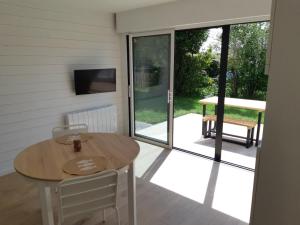 a patio with a table and a sliding glass door at ETABLISSEMENT CHEZ JULES in Ambleteuse
