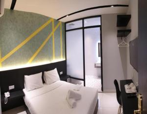 Postel nebo postele na pokoji v ubytování Suite Dreamz Hotel Banting