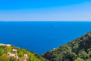 a view of the ocean from a hill with houses at Villa Mare in Amalfi