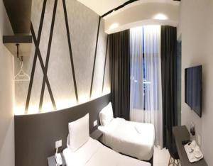Postel nebo postele na pokoji v ubytování Suite Dreamz Hotel Banting