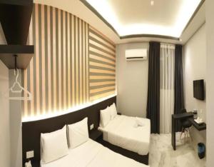 Postel nebo postele na pokoji v ubytování Suite Dreamz Hotel Banting