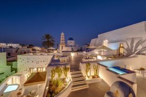 a view of a white building at night at Radiant Santorini in Mesaria