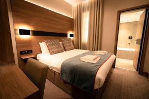 Säng eller sängar i ett rum på Oxford Hotel