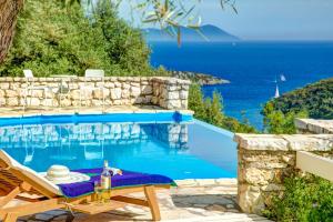 a villa with a swimming pool with a table and a view of the ocean at SivotaBayVillas Lefkada - 3 bedrooms villas with sea view & private pool in Sivota
