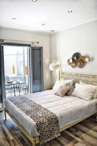A bed or beds in a room at Naxos Enjoy Apartments