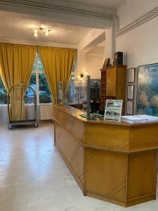 a lobby with a reception desk in a building at OCEANA Beach Hotel in Paralia Panteleimonos