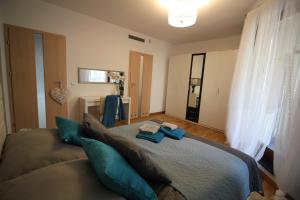 a bedroom with a large bed with blue pillows at Apartament Centrum Krawiecka 2 in Wrocław
