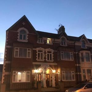 a large brown building with a sign on it at WiseStay in Cardiff