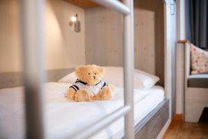 A bed or beds in a room at JUFA Hotel Eisenerzer Ramsau