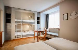 A bed or beds in a room at JUFA Hotel Eisenerzer Ramsau