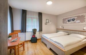 A bed or beds in a room at JUFA Hotel Eisenerzer Ramsau