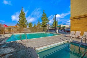 a swimming pool with chairs next to a building at La Quinta by Wyndham Manteca - Ripon in Ripon