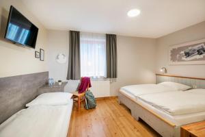 A bed or beds in a room at JUFA Hotel Eisenerzer Ramsau