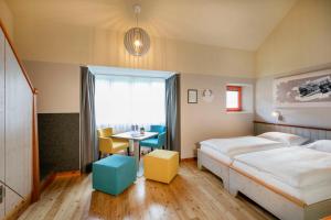 A bed or beds in a room at JUFA Hotel Eisenerzer Ramsau