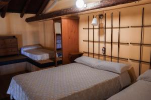 a bedroom with two beds and a dresser at Fabrica de Harina in Ventas con Peña Aguilera