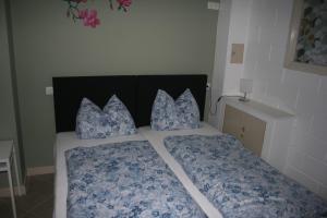 - un lit avec des draps et des oreillers bleus et blancs dans l'établissement The Butterfly Luxe appartement met private Parking, à Zandvoort