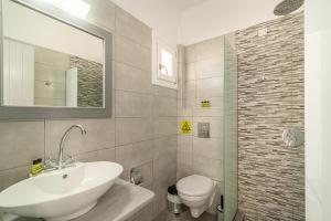 a bathroom with a sink and a toilet at Marianna Hotel in Perissa