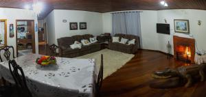 a living room with a table and a living room with a couch at Sítio Nicolau - Maravilhoso sítio nas Montanhas em Domingos Martins! in Domingos Martins