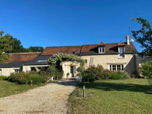 a house with a gravel driveway in front of it at la Chambre des Dames in Vallères