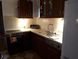 a kitchen with a sink and a counter top at László Apartman in Tihany