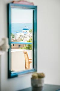 a window with a view of a building at Marianna Hotel in Perissa