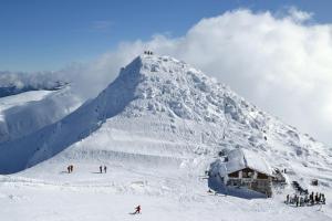 a group of people on a snow covered mountain at Jasna 96 II in Demanovska Dolina +9 photos