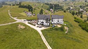 an aerial view of a house on a hill at Pensiunea Soarelui in Fundata