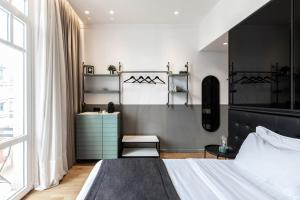 a bedroom with a bed with a black headboard at The Modernist Thessaloniki in Thessaloniki