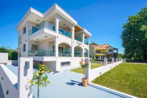 a large white house with a yard at Maria Elena Suites in Limenas
