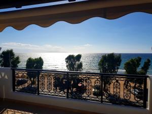 a view of the ocean from a balcony at Aphrodite's Apartments in Artemida