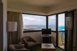 a room with a large window with a view of the ocean at Plaza Hotel Alexandria in Alexandria