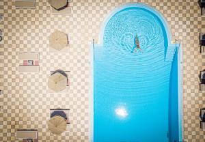 a person in the water in a swimming pool at Marianna Hotel in Perissa