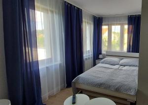 Ένα ή περισσότερα κρεβάτια σε δωμάτιο στο Pokoje Gościnne Cztery Wiatry