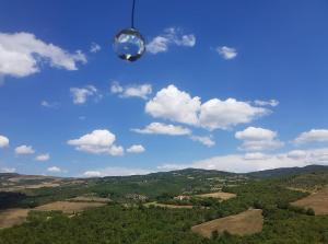 a person flying a kite high in the air at Agriturismo Grossola in Castiglione dʼOrcia