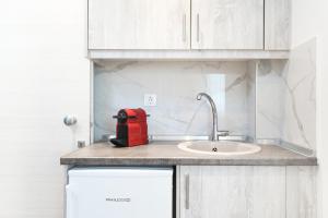 a red appliance sitting on top of a kitchen counter at Maria Elena Suites in Limenas