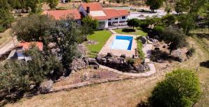 an aerial view of a home with a swimming pool in a yard at Quinta do Prado Verde in Vilar Formoso