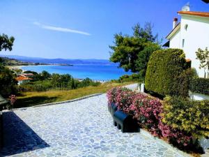 a view of a house with bushes and flowers at Dasea Houses in Ormos Panagias