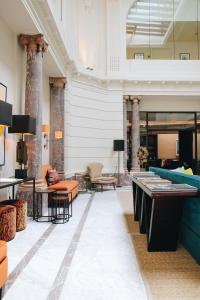 a lobby with a pool table and chairs at Hotel FRANQ in Antwerp
