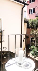 a glass cup on a table on a balcony at La Corte dell'Ulivo in Locarno