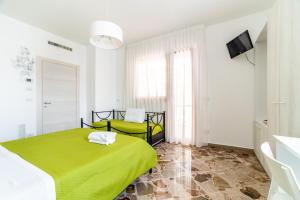 Postel nebo postele na pokoji v ubytování Le Calette Rooms - Puglia Mia Apartments