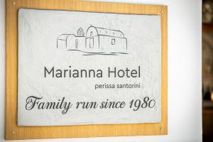a sign for a hotel with a drawing of a building at Marianna Hotel in Perissa